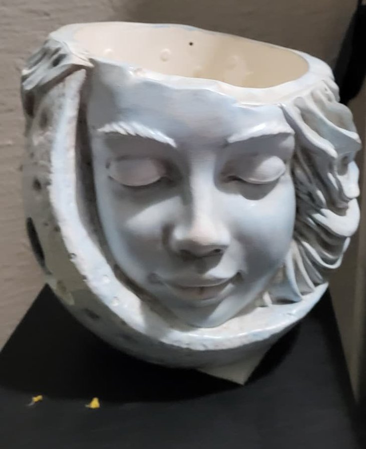 Before: a phone photo of the moon face planter on a dark surface